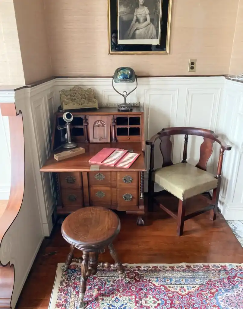 Antique Tiffany lamp place on a historic wooden desk in The Barker Mansion.